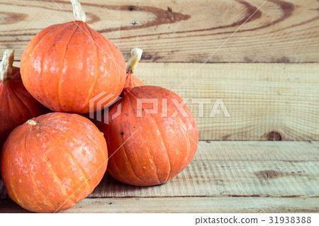 orange small pumpkin on wood table background 31938388