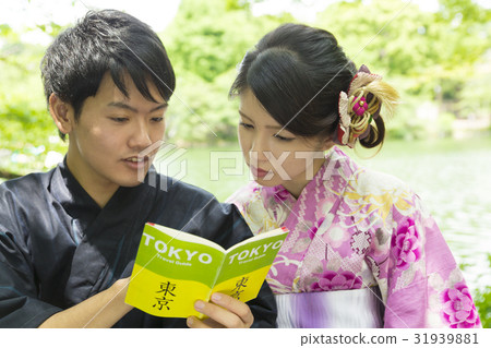 Yukata female couple seeing guidebook in Tokyo Yukata female couple seeing guidebook in Tokyo 31939881