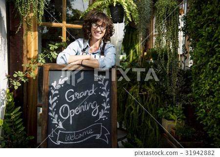 Adult Woman Standing with Grand Opening Sign 31942882