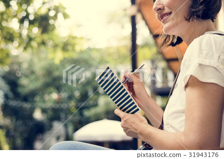 Adult Woman Sitting Hand Holding Notebook Thoughtful Adult Woman Sitting Hand Holding Notebook Thoughtful 31943176