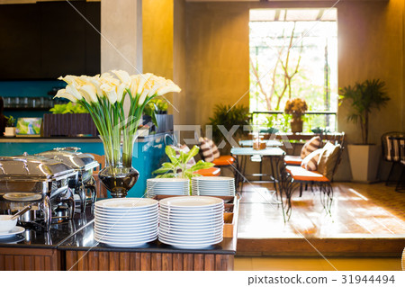 Beautiful white lilies with breakfast table Beautiful white lilies with breakfast table 31944494
