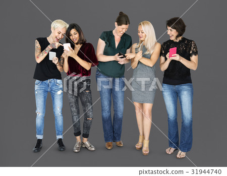 Happiness group of girlfriends smiling and conneted by mobile phone Happiness group of girlfriends smiling and conneted by mobile phone 31944740