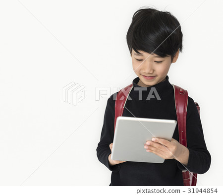 A boy with a backpack and tablet. A boy with a backpack and tablet. 31944854