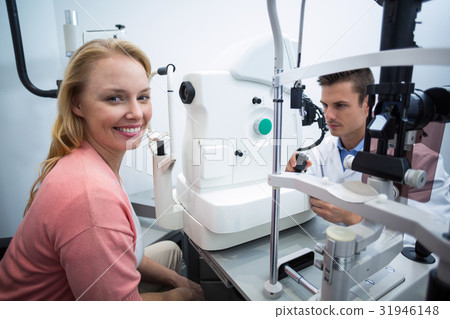 Female patient smiling in ophthalmology clinic Female patient smiling in ophthalmology clinic 31946148