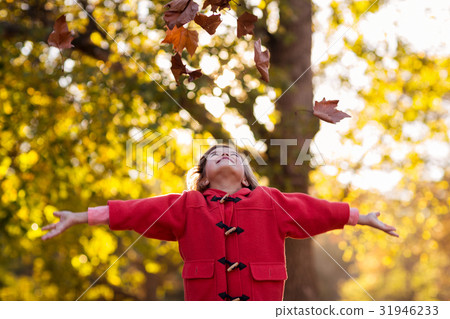 Happy girl throwing autumn leaves Happy girl throwing autumn leaves 31946233