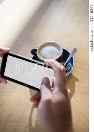 Female hands photographing a coffee cup Female hands photographing a coffee cup 31946246