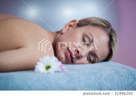 Beautiful woman lying on a massage bed Beautiful woman lying on a massage bed 31946293