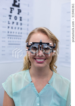 Female patient looking through messbrille during eye examination Female patient looking through messbrille during eye examination 31946361