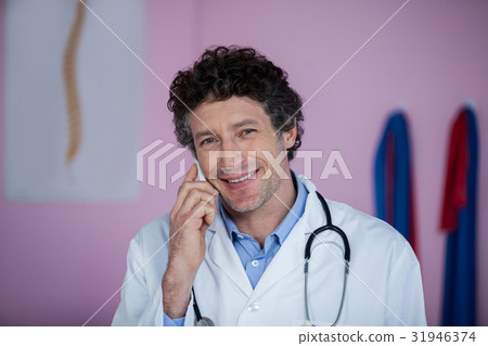 Portrait of physiotherapist talking on mobile phone Portrait of physiotherapist talking on mobile phone 31946374