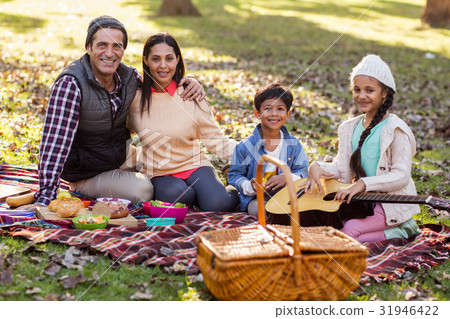 Portrait of family relaxing at park Portrait of family relaxing at park 31946422