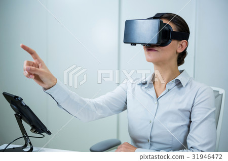 Woman using virtual reality headset Woman using virtual reality headset 31946472