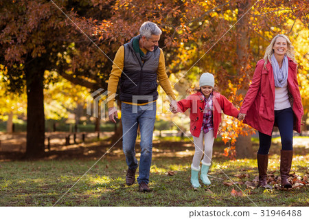 Family walking at park during autumn Family walking at park during autumn 31946488