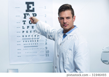 Optometrist pointing at eye chart 31946493