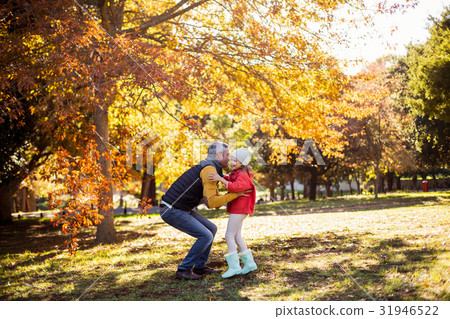 Father with daughter at park during autumn 31946522