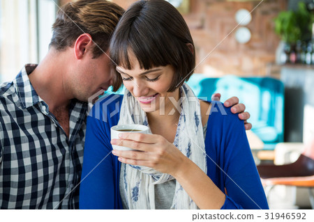 Couple embracing in coffee shop Couple embracing in coffee shop 31946592