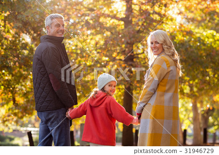 Portrait of happy family against trees Portrait of happy family against trees 31946729