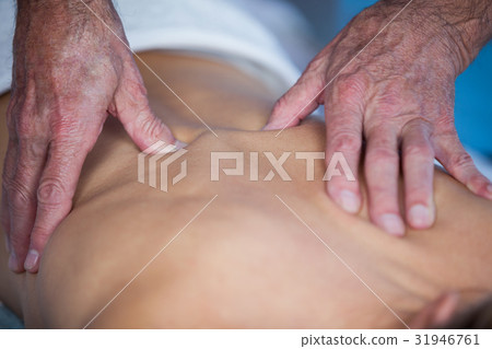 Woman receiving back massage from physiotherapist Woman receiving back massage from physiotherapist 31946761