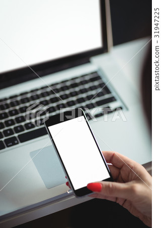 Mature student using mobile phone 31947225