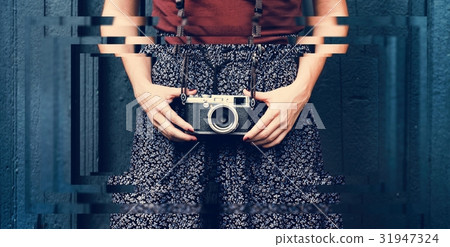 Traveler photographer woman holding film camera 31947324