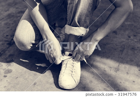 Man tries to tie his shoelaces Man tries to tie his shoelaces 31947576