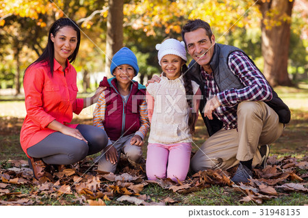 Happy family at park during autumn 31948135