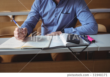 Mature student writing notes 31948171