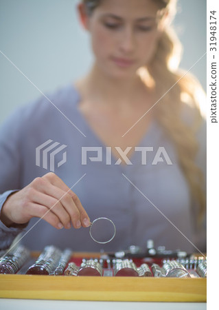 Woman arranging messbrille in tool box Woman arranging messbrille in tool box 31948174