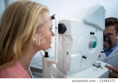 Female patient looking through coreometry Female patient looking through coreometry 31948371