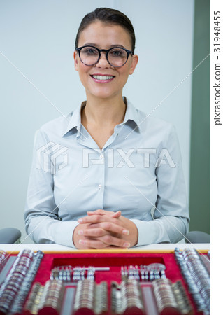 Optician sitting with tool box on table Optician sitting with tool box on table 31948455