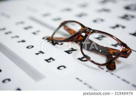 Close-up of spectacles on eye chart 31948479