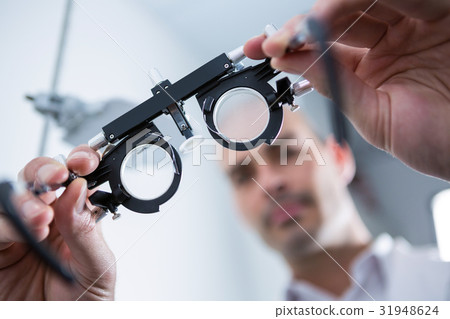 Close-up of optometrist holding messbrille 31948624