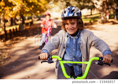 Portrait of smiling boy riding bicycle Portrait of smiling boy riding bicycle 31948857