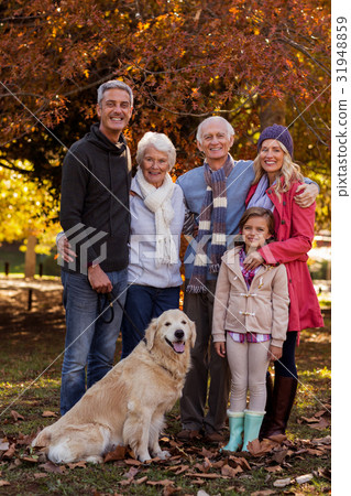 Happy family standing with dog at park 31948859
