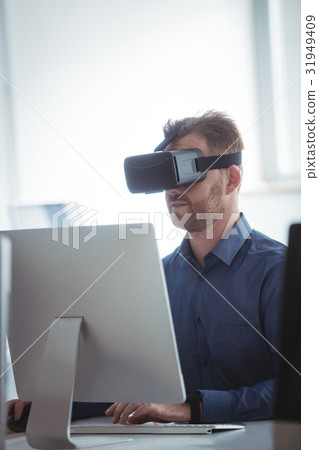 Mature student in virtual reality headset using computer 31949409
