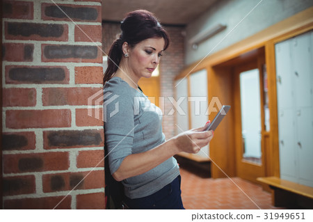 Mature student using mobile phone in the locker room 31949651