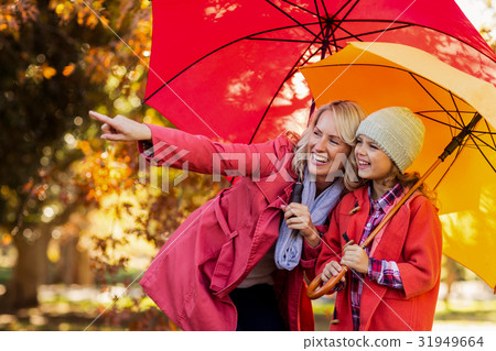 Happy woman pointing while standing by daughter 31949664