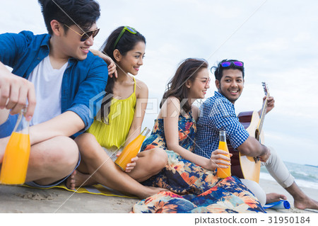 A picture of a group of four friends sitting, smiling and relaxing 31950184