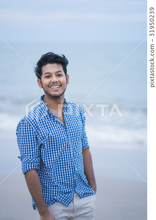 A happy man is standing and putting his hand in pocket 31950239