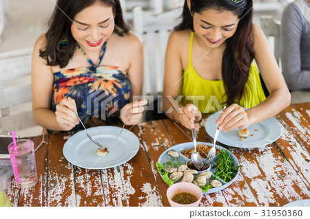 图库照片: the two asian girls have a meal together