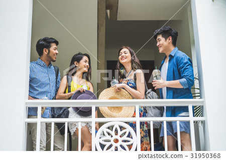 A photo of four people standing and smiling near the balcony 31950368