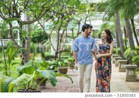 The couple is walking and dating in the campus of garden 31950383