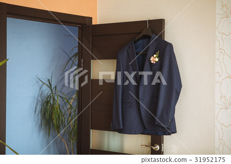 Wedding boutonniere on suit jacket of groom Wedding boutonniere on suit jacket of groom 31952175