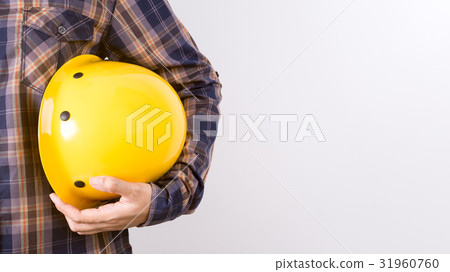 Engineer holding a helmet on a white background. Engineer holding a helmet on a white background. 31960760