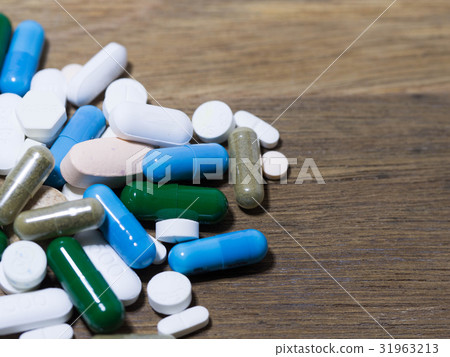 Drug and capsule is on the wooden table Drug and capsule is on the wooden table 31963213