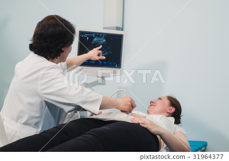 Doctor using ultrasound and screening stomach of 31964377