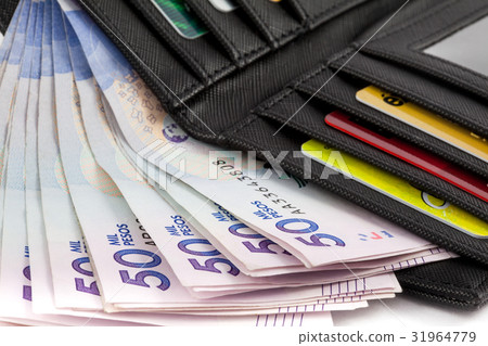 Black wallet filled with money and cards Black wallet filled with money and cards 31964779
