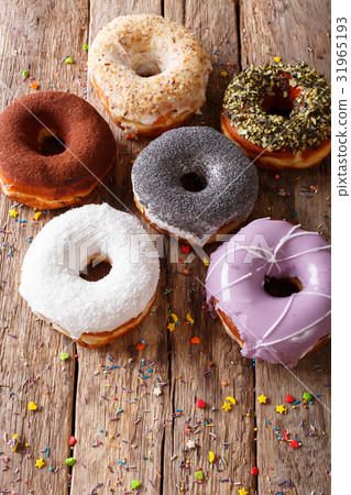 圖庫照片: multicolored donuts with fillings close-up