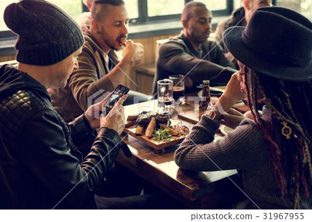 Friends all together at restaurant having meal Friends all together at restaurant having meal 31967955