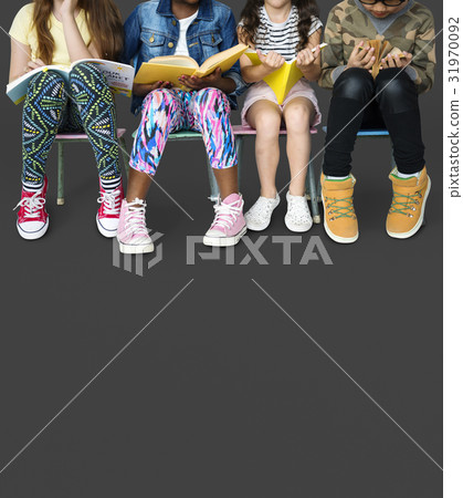 Diverse group of kids sitting in a row reading books Diverse group of kids sitting in a row reading books 31970092