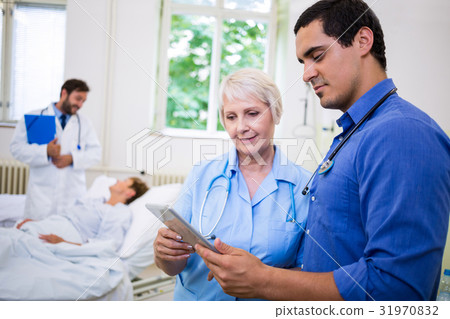 Doctor and nurse using digital tablet Doctor and nurse using digital tablet 31970832
